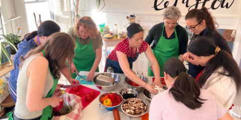 A group of faculty and staff crafting a healthy meal together